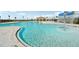 Stunning community pool with a fun splash feature, zero entry, and a view of the covered seating area at 3586 Dahlia Dr, Lake Hamilton, FL 33851