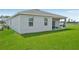 Backyard featuring a covered patio with outdoor seating and lush green grass at 3588 Dahlia Dr, Haines City, FL 33844