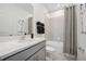 A modern bathroom with a single sink vanity and a shower-tub combo with a patterned curtain at 3588 Dahlia Dr, Haines City, FL 33844