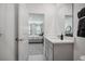 Well-lit bathroom featuring a modern sink with gray cabinetry and a view into the primary bedroom at 3588 Dahlia Dr, Haines City, FL 33844