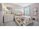 Bright bedroom featuring a floral comforter, tufted headboard and gold framed mirror at 3588 Dahlia Dr, Haines City, FL 33844