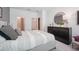 A cozy bedroom featuring a dresser and an open ensuite bathroom and closet at 3588 Dahlia Dr, Haines City, FL 33844