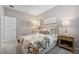 Bedroom featuring a floral comforter, tufted headboard, and a nightstand with lamp at 3588 Dahlia Dr, Haines City, FL 33844