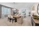 Well-lit dining area featuring a large table, modern chandelier, and seamless access to the living room at 3588 Dahlia Dr, Haines City, FL 33844