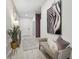Bright hallway featuring light wood floors, a modern bench, and a striking zebra print art piece at 3588 Dahlia Dr, Haines City, FL 33844