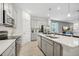 A well-lit kitchen features gray cabinets, a center island, and stainless steel appliances at 3588 Dahlia Dr, Haines City, FL 33844