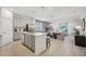 An open-concept kitchen and dining area features a center island and stainless steel appliances at 3588 Dahlia Dr, Haines City, FL 33844