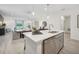 A modern kitchen island, dining, and living area in an open floor plan at 3588 Dahlia Dr, Haines City, FL 33844
