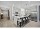 A modern kitchen features gray cabinets, a center island with seating, and stainless steel appliances at 3588 Dahlia Dr, Haines City, FL 33844