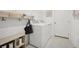 Bright laundry room featuring a front load washer and dryer and storage shelves at 3588 Dahlia Dr, Haines City, FL 33844