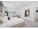Bright primary bedroom with carpeted floors, neutral tones, and views of an ensuite bathroom at 3588 Dahlia Dr, Haines City, FL 33844