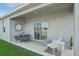 Covered patio with seating area, offering a comfortable outdoor living space at 3588 Dahlia Dr, Haines City, FL 33844