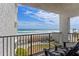 Balcony offering scenic ocean views, patio furniture, and a glimpse of community amenities, including a pool at 3747 S Atlantic Ave # 2050, Daytona Beach, FL 32118