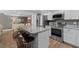 Kitchen featuring white cabinets, stainless steel appliances, and a granite countertop island with seating at 3747 S Atlantic Ave # 2050, Daytona Beach, FL 32118