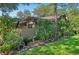 Exterior view of a home with lush landscaping and mature trees, creating a private oasis at 396 Newton, Longwood, FL 32779