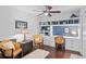 Well-lit office features custom built-ins, hardwood floors, and a ceiling fan at 396 Newton, Longwood, FL 32779