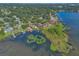 Stunning aerial shot showcasing a lakefront community with docks, waterfront properties, and dense vegetation at 4011 Teriwood Ave, Orlando, FL 32812