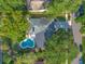 Aerial view of a home with a kidney-shaped pool and an expansive backyard surrounded by mature trees at 4011 Teriwood Ave, Orlando, FL 32812