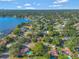 Picturesque aerial view of a lakeside community featuring homes and waterways under a bright sky at 4011 Teriwood Ave, Orlando, FL 32812