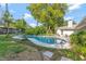 Charming backyard features a pool, a well-maintained lawn, and lush landscaping, creating a perfect outdoor oasis at 4011 Teriwood Ave, Orlando, FL 32812