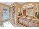 Bathroom featuring double sinks, wooden cabinets, and a shower-tub combination at 4011 Teriwood Ave, Orlando, FL 32812