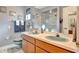 Bathroom featuring double sinks, a large mirror, and a glass-enclosed shower at 4011 Teriwood Ave, Orlando, FL 32812