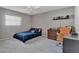 Spacious bedroom with a large window, dresser, and a comfortable study space at 4011 Teriwood Ave, Orlando, FL 32812