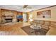 Inviting living room features a brick fireplace, wood floors, and a comfortable leather sectional sofa at 4011 Teriwood Ave, Orlando, FL 32812