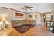 Open-concept living room featuring hardwood floors, a plush sectional, and views into the kitchen at 4011 Teriwood Ave, Orlando, FL 32812