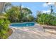 Inviting backyard pool with a spacious patio surrounded by lush greenery for ultimate privacy at 4011 Teriwood Ave, Orlando, FL 32812