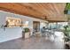 Relaxing sun room features a wooden ceiling, ceiling fan, built in bar and pass-through window to the kitchen at 4011 Teriwood Ave, Orlando, FL 32812
