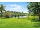 Lush backyard with a black metal fence and scenic water views at 408 Egret Place Dr, Winter Garden, FL 34787