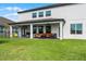 Spacious backyard with a covered patio and comfortable seating, perfect for outdoor enjoyment at 408 Egret Place Dr, Winter Garden, FL 34787