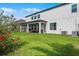 Large backyard with a covered patio, green grass, mature trees, and an exterior view of home at 408 Egret Place Dr, Winter Garden, FL 34787