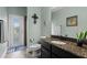Bathroom with granite vanity, toilet, and access door to the outside at 408 Egret Place Dr, Winter Garden, FL 34787