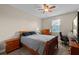 Comfortable bedroom with a ceiling fan, desk, and window for natural light at 408 Egret Place Dr, Winter Garden, FL 34787