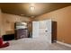 Spacious bonus room featuring a large TV, neutral carpet, and an open door to another room at 408 Egret Place Dr, Winter Garden, FL 34787