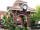 Winter Garden clock tower featuring brick arches and lush green plants at 408 Egret Place Dr, Winter Garden, FL 34787