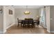 Cozy dining room with tile floors, decorative lighting, and a large wood dining table at 408 Egret Place Dr, Winter Garden, FL 34787
