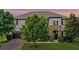 Charming home featuring a brick driveway, stone accents, a well-manicured lawn, and mature trees at 408 Egret Place Dr, Winter Garden, FL 34787