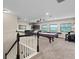 Spacious game room features a pool table, bar area, and scenic views at 408 Egret Place Dr, Winter Garden, FL 34787