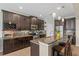 Well-equipped kitchen boasts granite countertops, stainless appliances and breakfast bar at 408 Egret Place Dr, Winter Garden, FL 34787