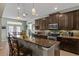 Gourmet kitchen boasts granite countertops, stainless steel appliances and a cozy breakfast bar at 408 Egret Place Dr, Winter Garden, FL 34787