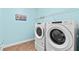 Modern laundry room equipped with a washer and dryer for convenience at 408 Egret Place Dr, Winter Garden, FL 34787