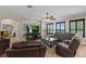 Stylish living room featuring a modern accent wall and comfortable leather seating at 408 Egret Place Dr, Winter Garden, FL 34787