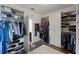 Walk-in closet featuring custom shelving, drawers, and ample storage with a wood-look floor at 408 Egret Place Dr, Winter Garden, FL 34787