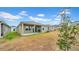 A cozy covered patio extends to the green lawn at 415 Overpool Ave, Davenport, FL 33896