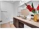 Well-lit bathroom with a vanity, granite countertop, a mirror, and decorative accents for a touch of elegance at 415 Overpool Ave, Davenport, FL 33896