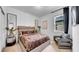 Stylish bedroom featuring a plush bed, elegant decor, and a cozy sitting area, illuminated by natural light at 415 Overpool Ave, Davenport, FL 33896