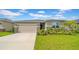 Well-manicured lawn and tasteful landscaping enhance the curb appeal of this lovely home at 415 Overpool Ave, Davenport, FL 33896